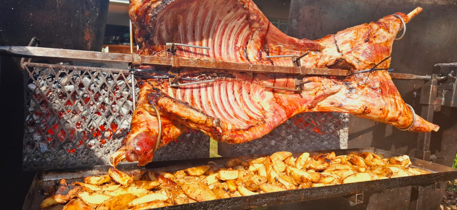 Whole roast turning golden brown over the fire